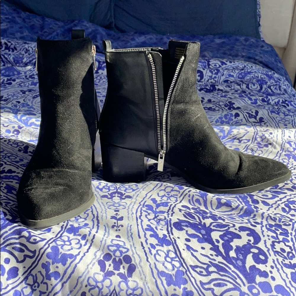 Black heeled booties with zipper accents